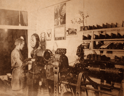 Photo of Clyde Olson repairing shoes.